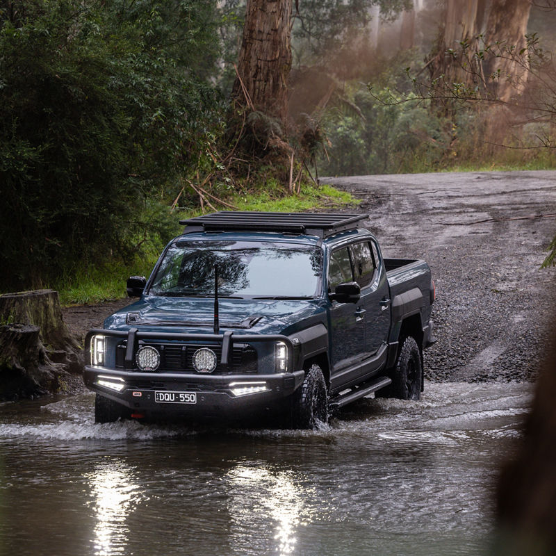 Blue Kia Tasman Crossing River