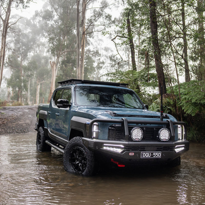 Blue Kia Tasman Crossing River