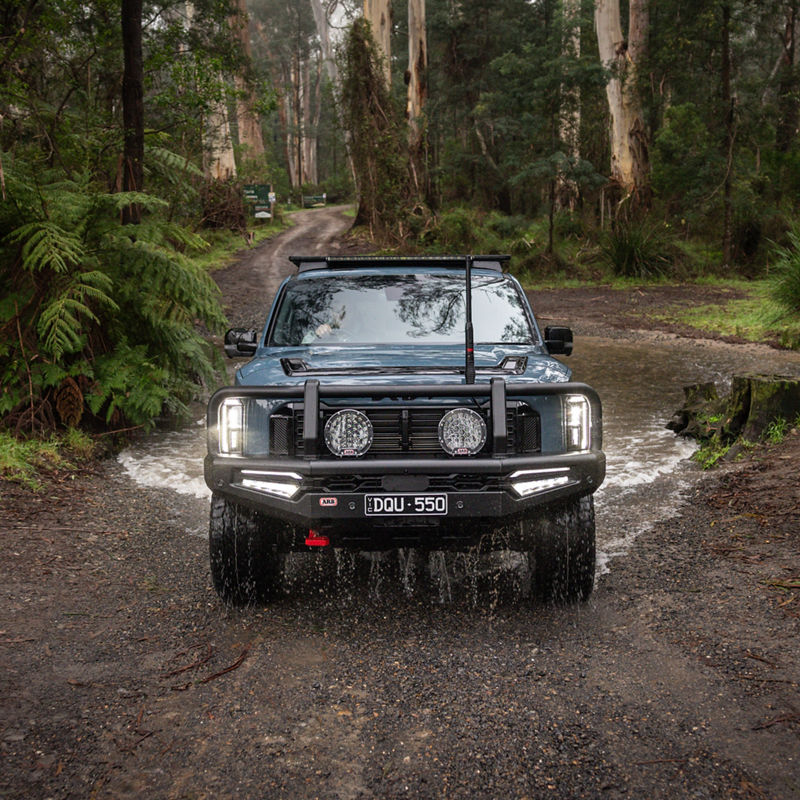 Blue Kia Tasman Crossing River
