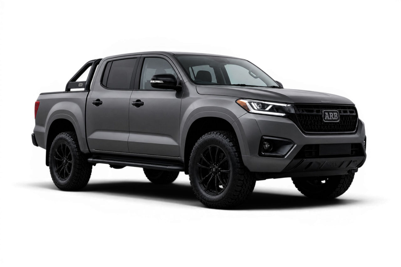 Front three quarter view of a 4WD dual cab ute fitted with a sports bar and side steps on a studio background.