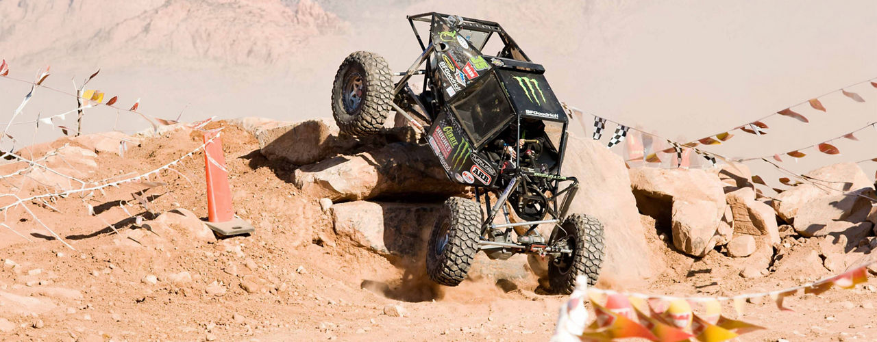 Off road racing buggy navigating a rocky obstacle course during an ARB Off Road Racing Series event.