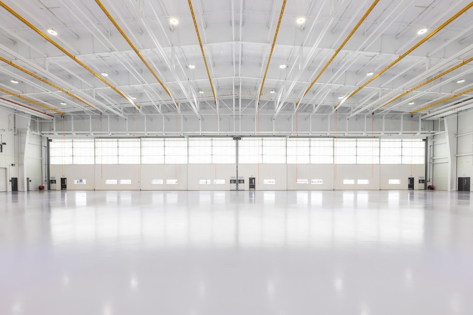 Aircraft maintenance hangar interior at Duncan Aviation featuring open-span workspace and integrated overhead systems.