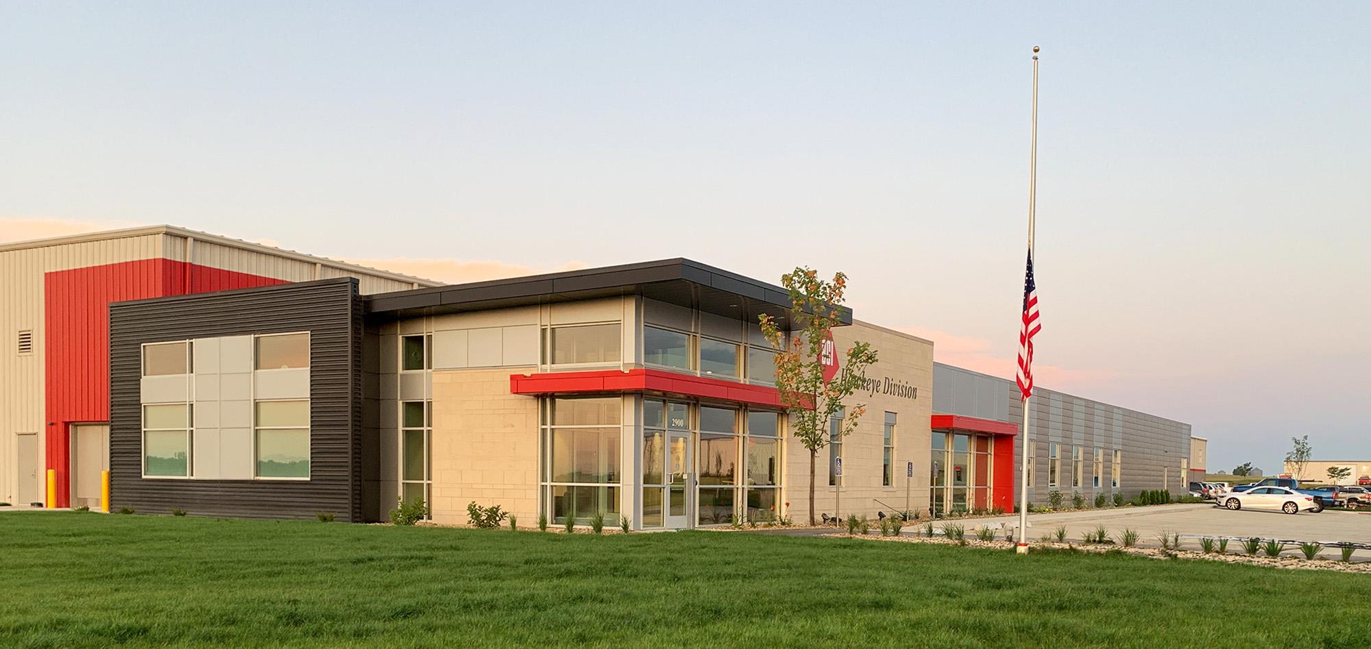 Industrial manufacturing facility featuring architectural metal wall panels, office frontage and large-scale steel building construction.