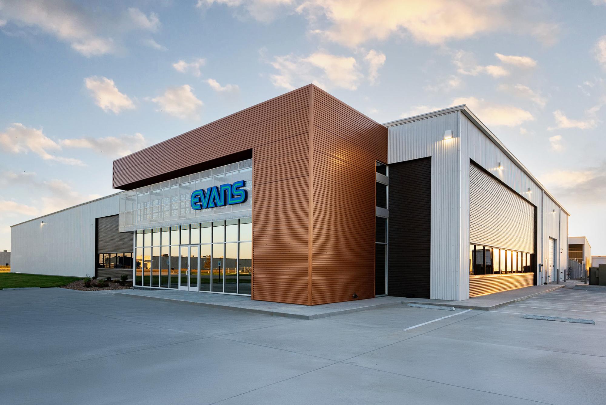 Exterior view of the Evans Building Company headquarters featuring integrated office space, service bays and contemporary metal facade design.