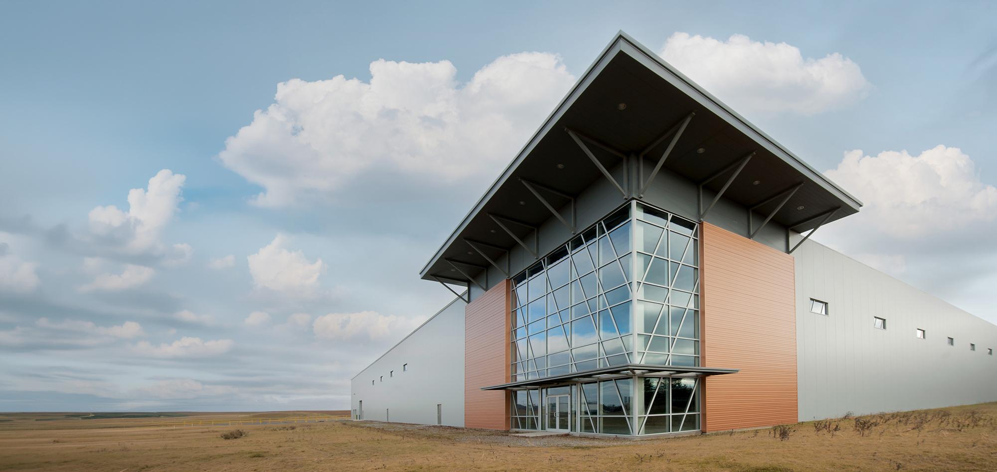 Exterior view of the Interstate Park Spec Building featuring an energy-efficient building envelope, integrated glazing systems and coordinated architectural design developed to support operational durability and a clean professional appearance.