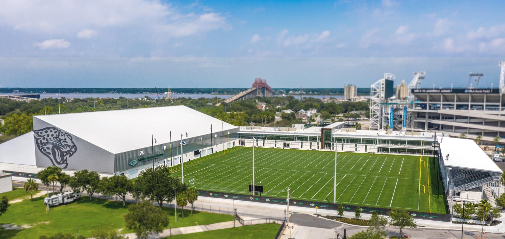 Aerial view of the Jacksonville Jaguars Indoor Practice Facility featuring integrated indoor training space, outdoor practice fields and coordinated performance environments designed to support athlete development, recovery and team operations.