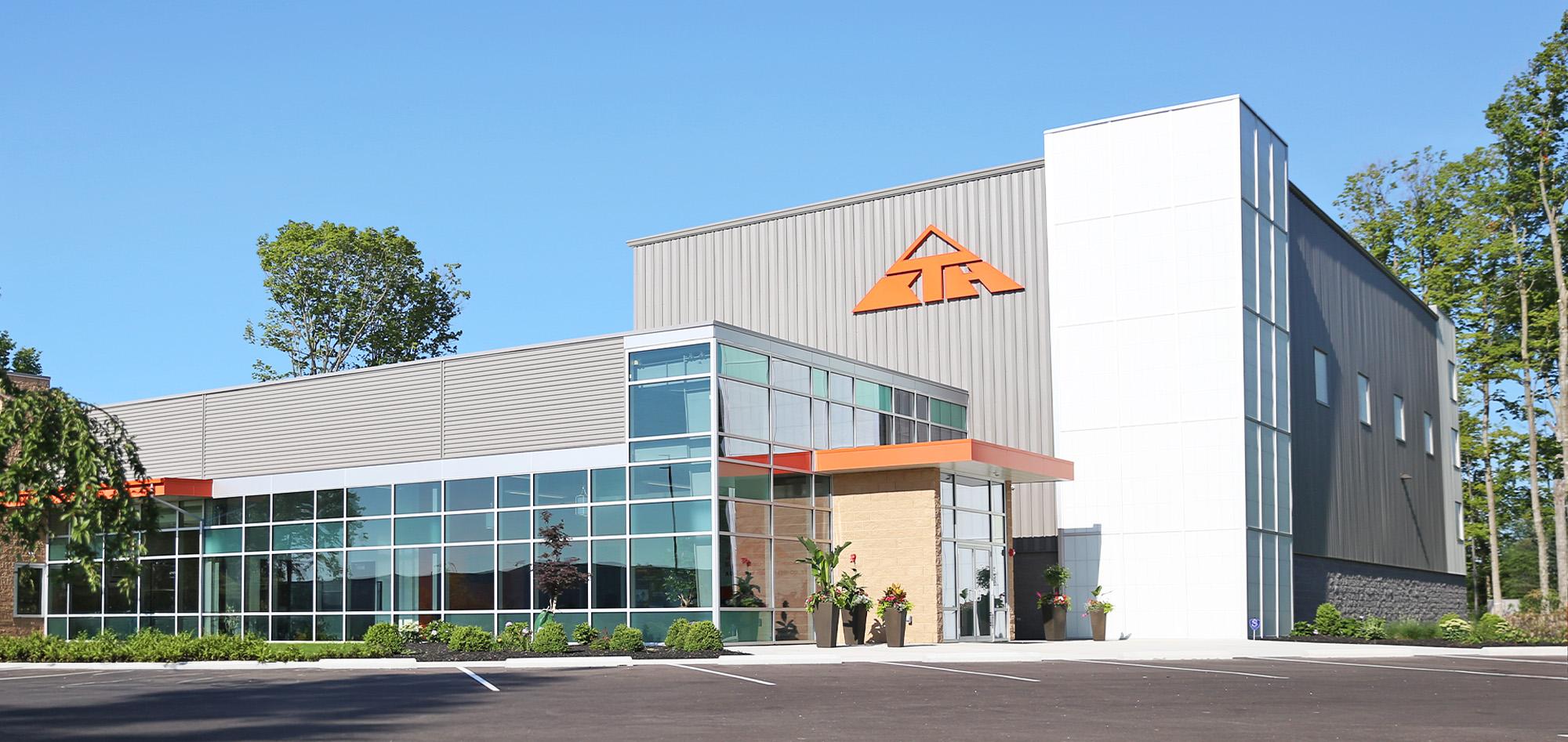 Commercial manufacturing office building featuring architectural metal wall panels, structural steel framing and modern corporate facility design.