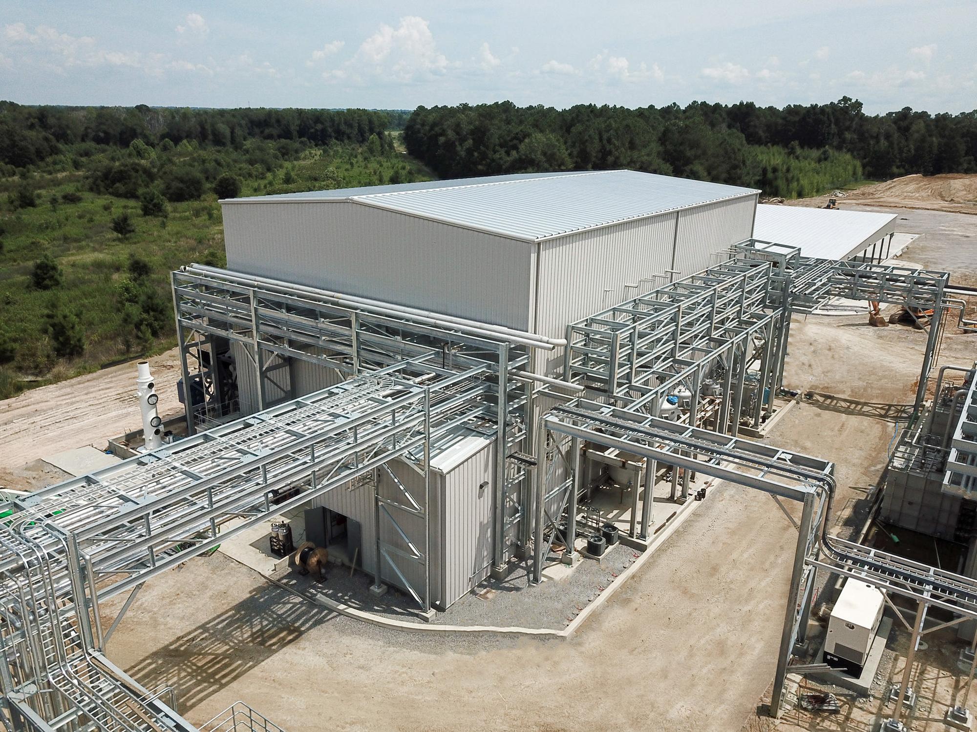 Aerial view of the MIWON Specialty Chemicals USA facility showing integrated manufacturing structures connected through coordinated process piping and utility systems within a multi-building industrial campus.