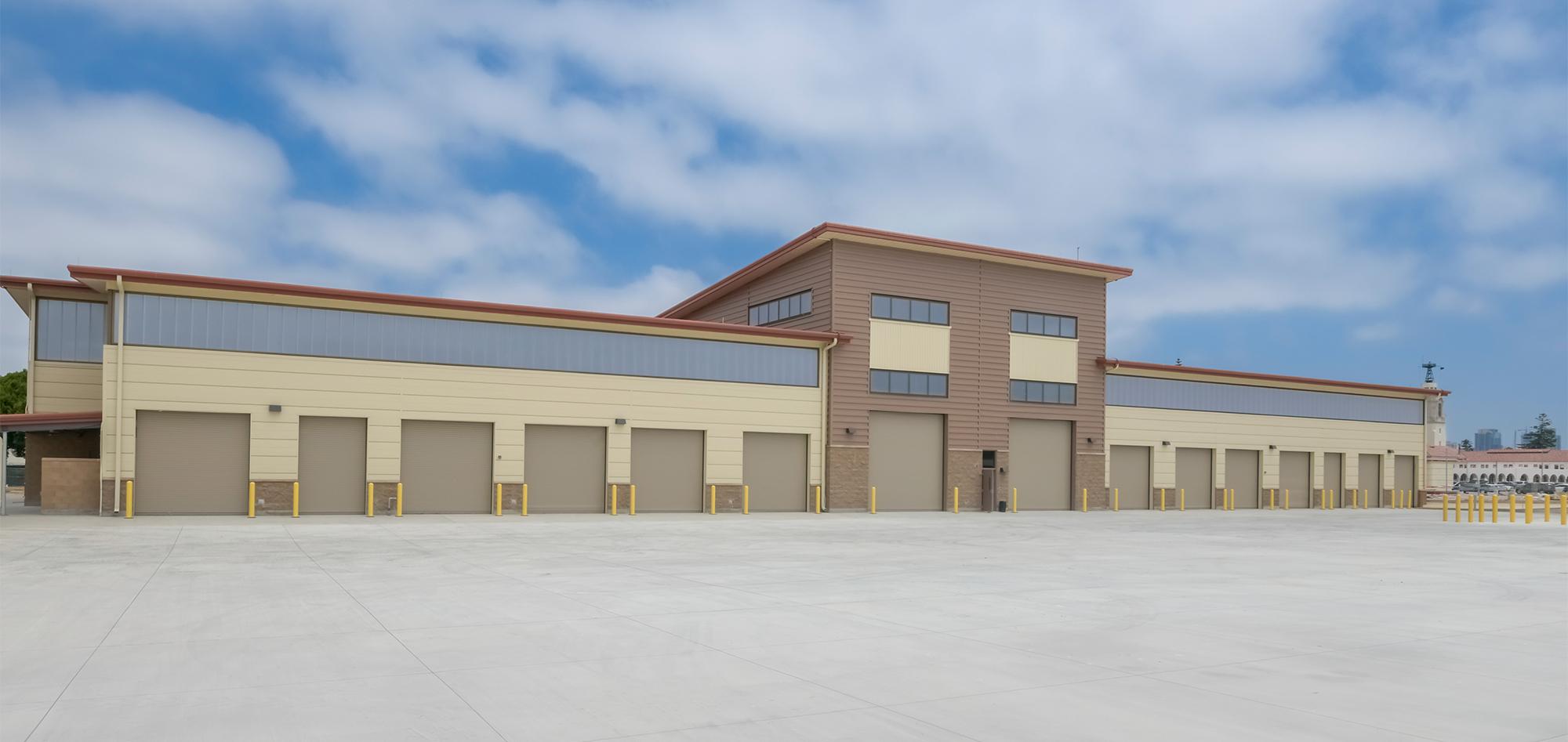 Exterior view of the U.S. Navy Forklift Rework Facility featuring integrated service bays, centralized operations space and a coordinated government facility designed to support equipment repair and training.