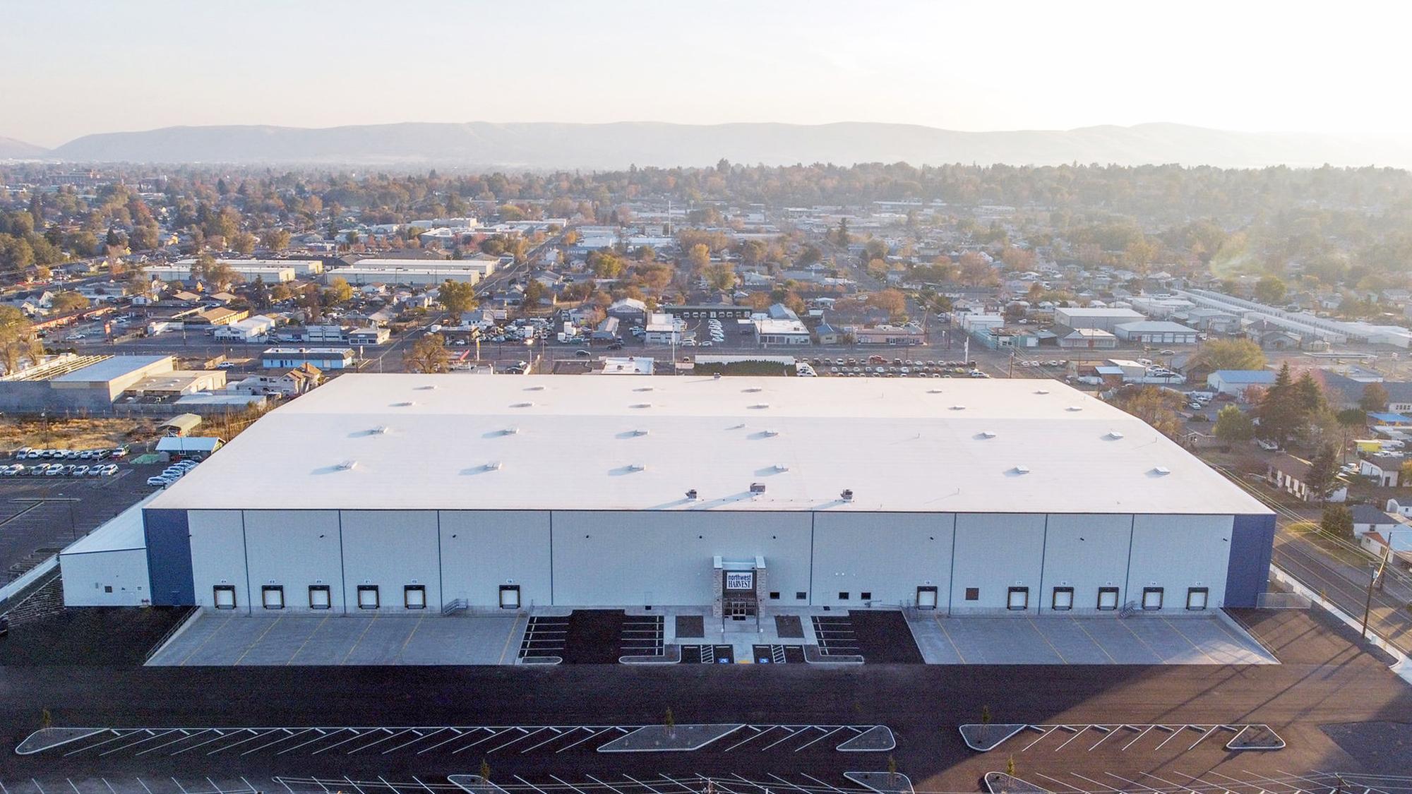 Aerial view of the Northwest Harvest Distribution Center featuring a large-scale food distribution facility designed to support high-volume logistics, integrated cold storage and faster statewide delivery operations.