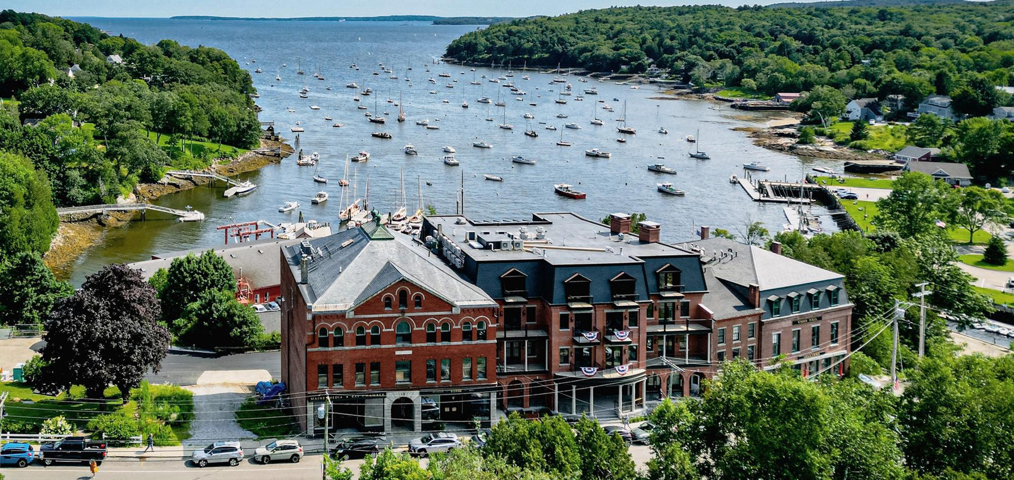 Aerial view of the Rockport Harbor Hotel featuring integrated historic and new construction elements, coordinated waterfront hospitality design and a unified hotel environment developed to connect existing structures with precision and long-term performance.