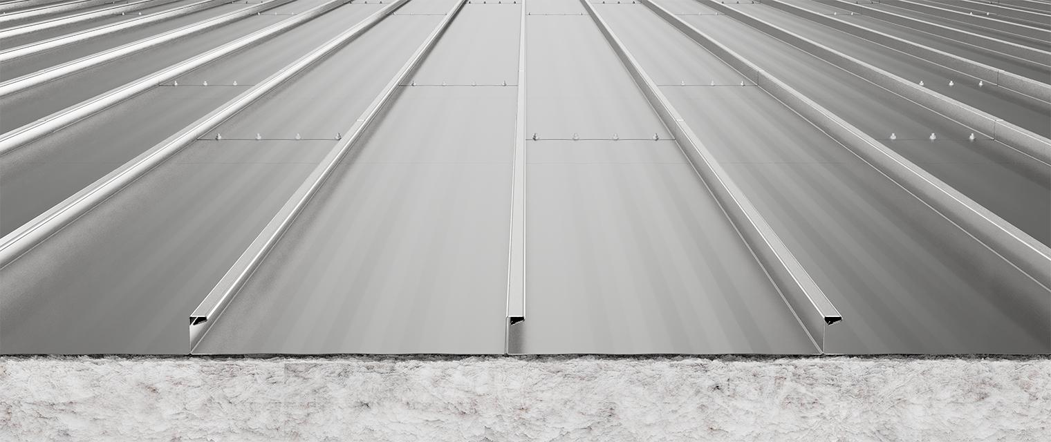 Standing seam metal roof panels extending in parallel lines with clean seams and light reflecting across the surface