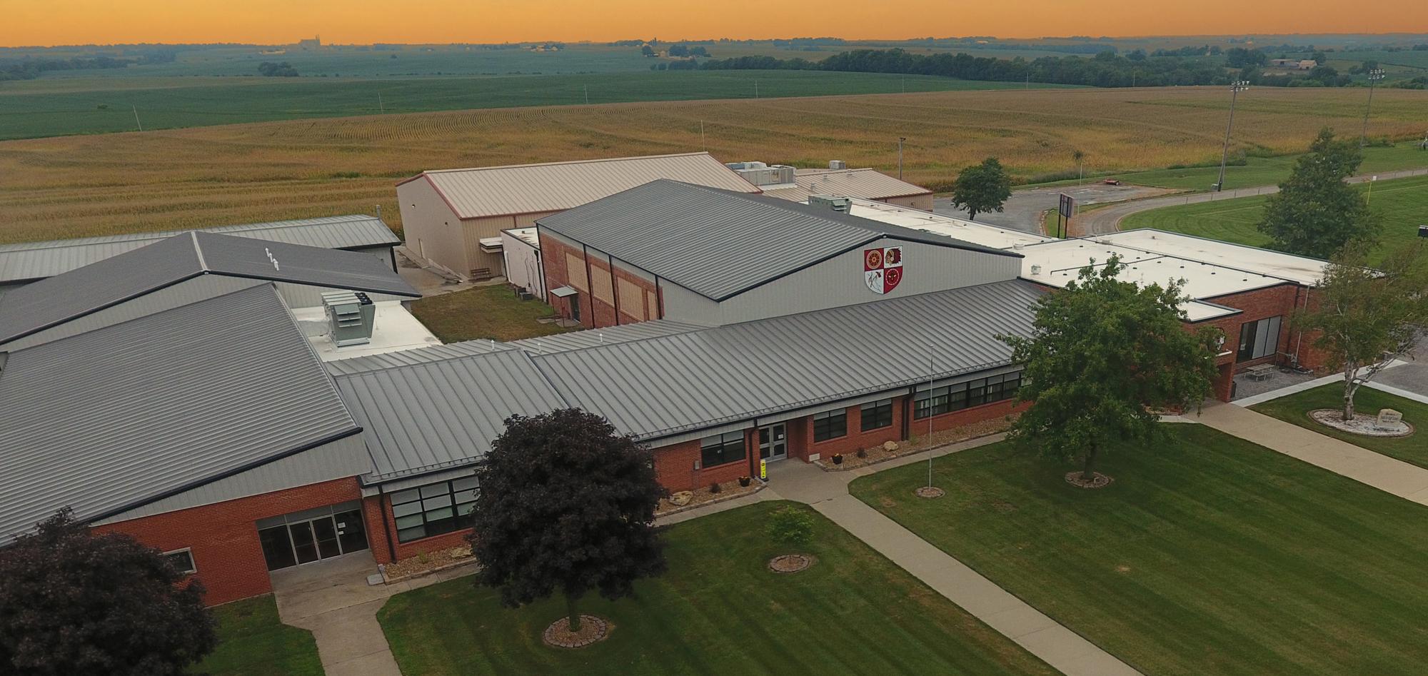 Aerial view of the Santa Fe Schools Roof Retrofit project featuring coordinated roofing systems across multiple educational building sections designed to improve facility protection, operational continuity and long-term performance during ongoing school use.