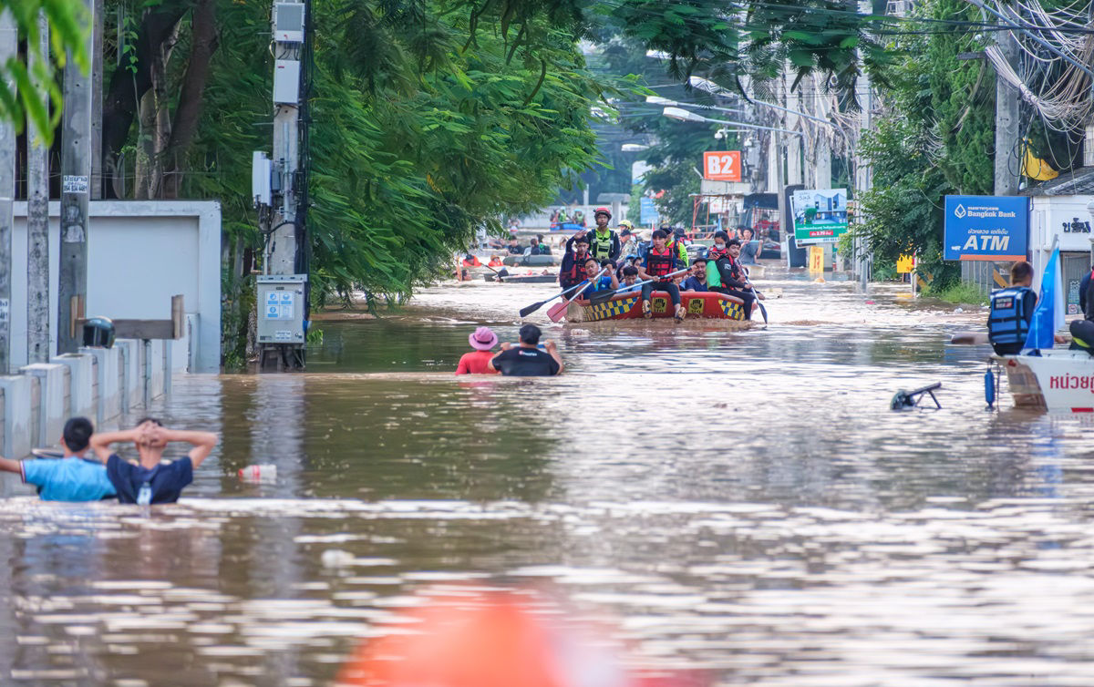 Chiang Mai Thailand-10 05 2024: Rescue team help victims of flood trying to flee and and help each other to seek help and refuge. The rain bombs attacked north of Thailand and cause people in danger.