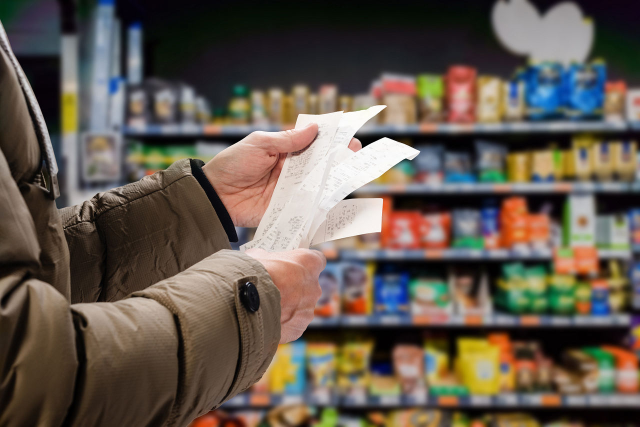 grocery shopper looking at receipts