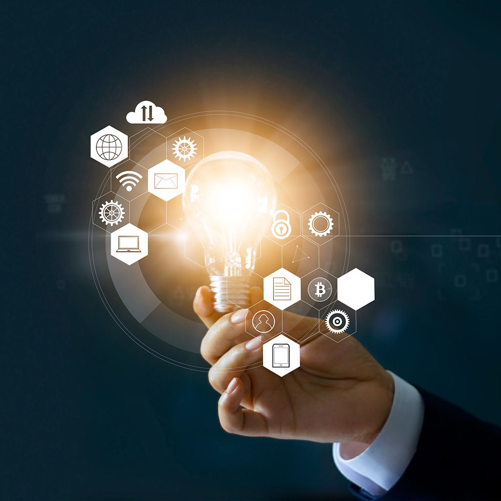 hand holding a lightbulb with multiple concepts springing out