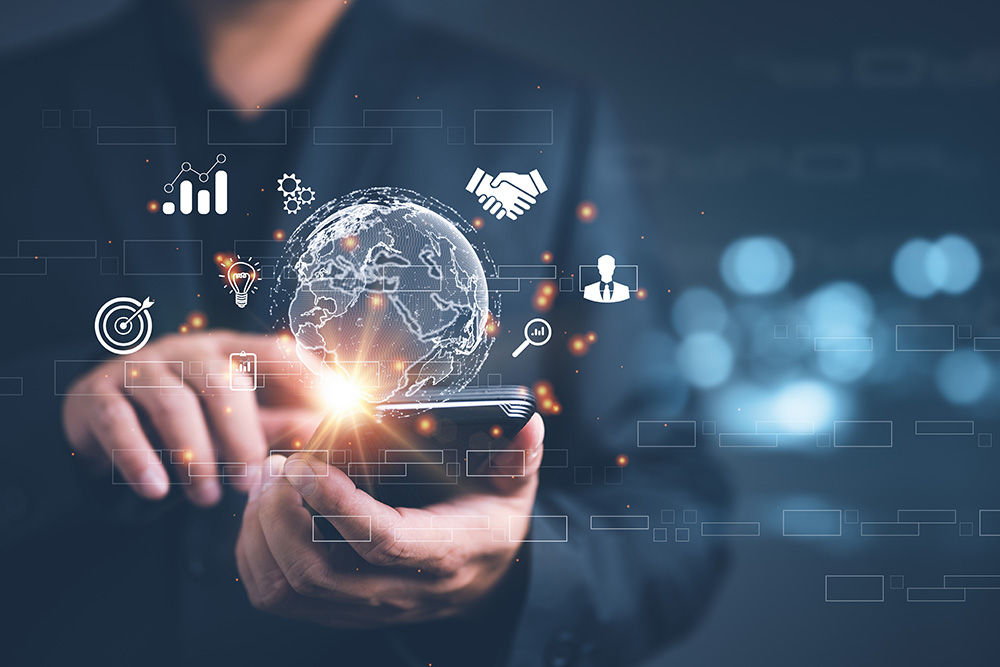 man in smart casual holding phone accessing digital services with icons overlaid around front of screen area