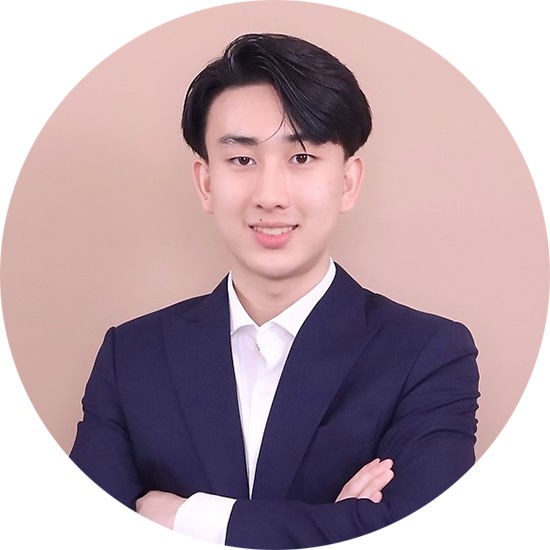 Kulkitti Paphakorn portrait photo an Asian man with short black hair in a suit and white shirt with crossed arms