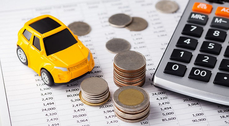 Car and coins with calculator on financial statement
