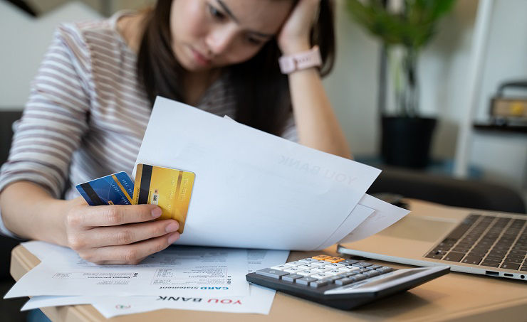 stressed woman trying money to pay credit card debt and many expenses bills such as electricity bill,water bill,internet bill,phone bill during covid-19 or coronavirus outbreak at home