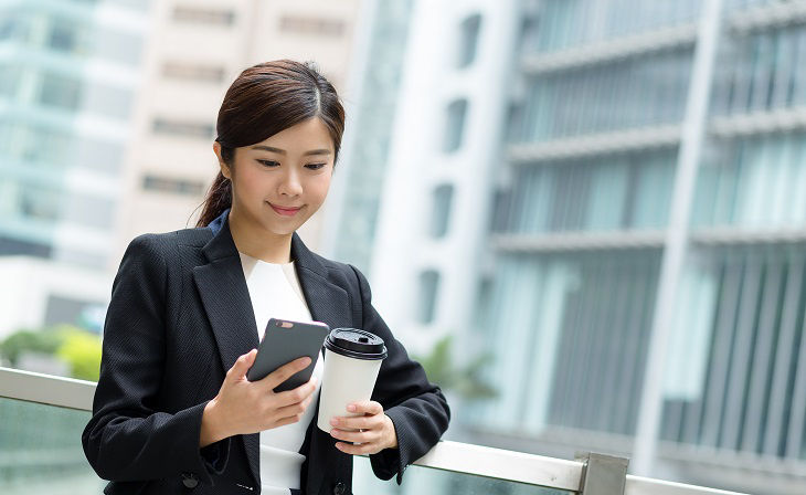 Businesswoman sending message with smartphone; Shutterstock ID 413539204; purchase_order: BOT; job: ; client: ; other: 