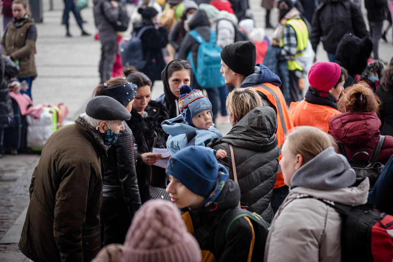 Lviv, Ukraine - March 3, 2022: A crowd of people transiting through Lviv stand outside the Lviv train station.