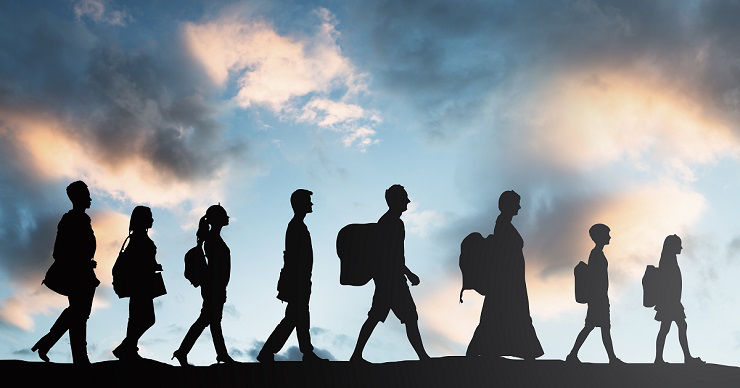 Silhouette Of Refugees People With Luggage Walking In A Row