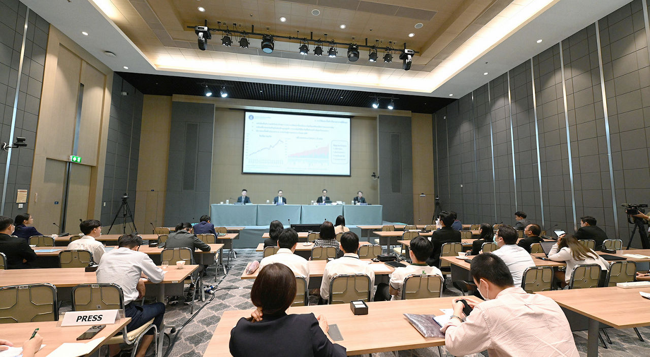 conference room with participants four panelists and slide projector