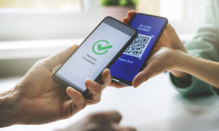 qr code payment - person paying with mobile phone