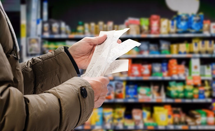 Minded man viewing receipts in supermarket and tracking prices; Shutterstock ID 1980000383; purchase_order: BOT; job: ; client: ; other: 