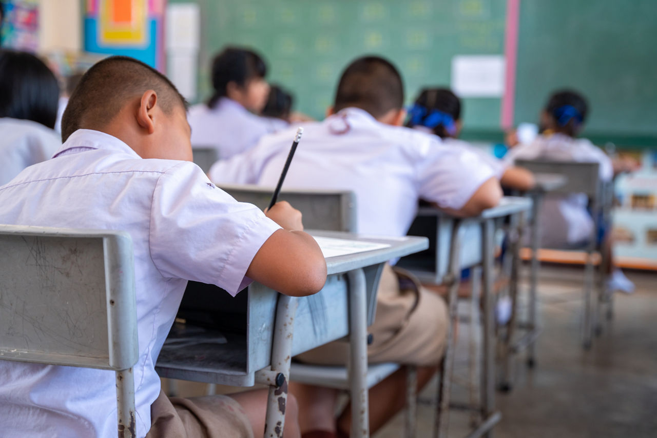 Thai elementary school poor student are writing in the classroom,  Thai students group Education evaluation concept