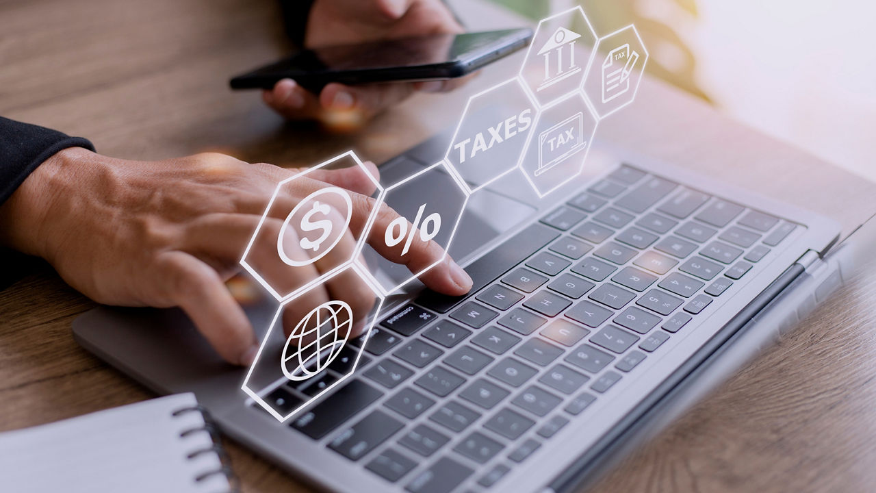 Busines using a computer to complete Individual income tax return form online for tax payment. Government, state taxes. Data analysis, paperwork, financial research, report. Calculation tax return.; Shutterstock ID 2198685893; purchase_order: BOT; job: ; client: ; other: 