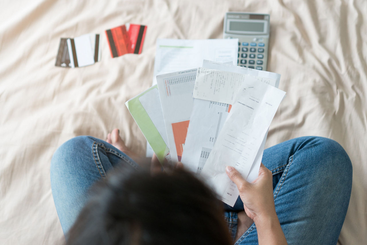 stressed woman trying money to pay credit card debt and many expenses bills such as electricity bill,water bill,internet bill,phone bill during covid-19 or coronavirus outbreak at home