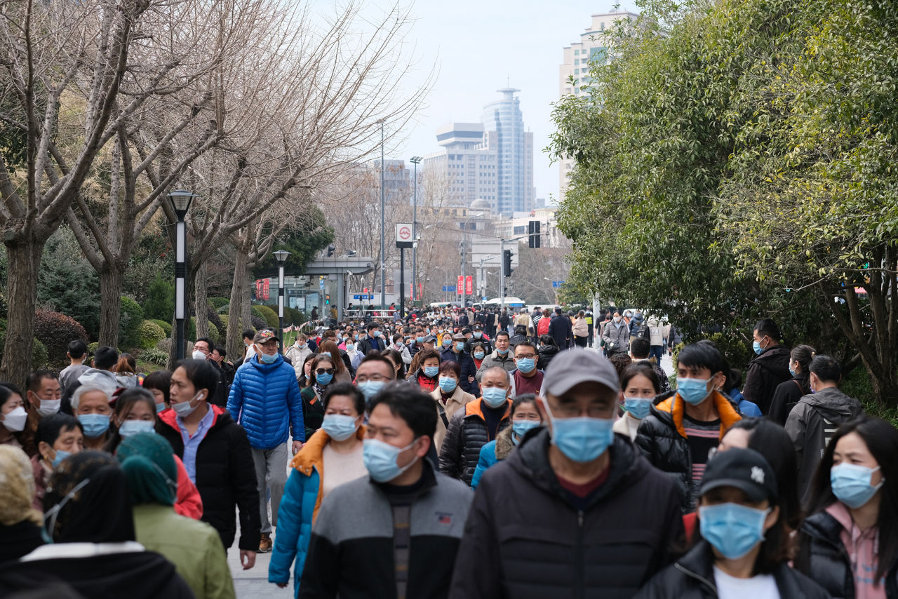 Shanghai.China-Feb.2021: crowded Chinese people walking on street in face mask to prevent coronavirus