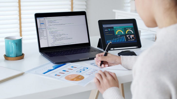 Back rear view of young asian woman, freelance data scientist work remotely at home coding programmer on Big data mining, AI data engineering, IT Technician Works on Artificial Intelligence Project.; Shutterstock ID 2160981465; purchase_order: BOT; job: ;