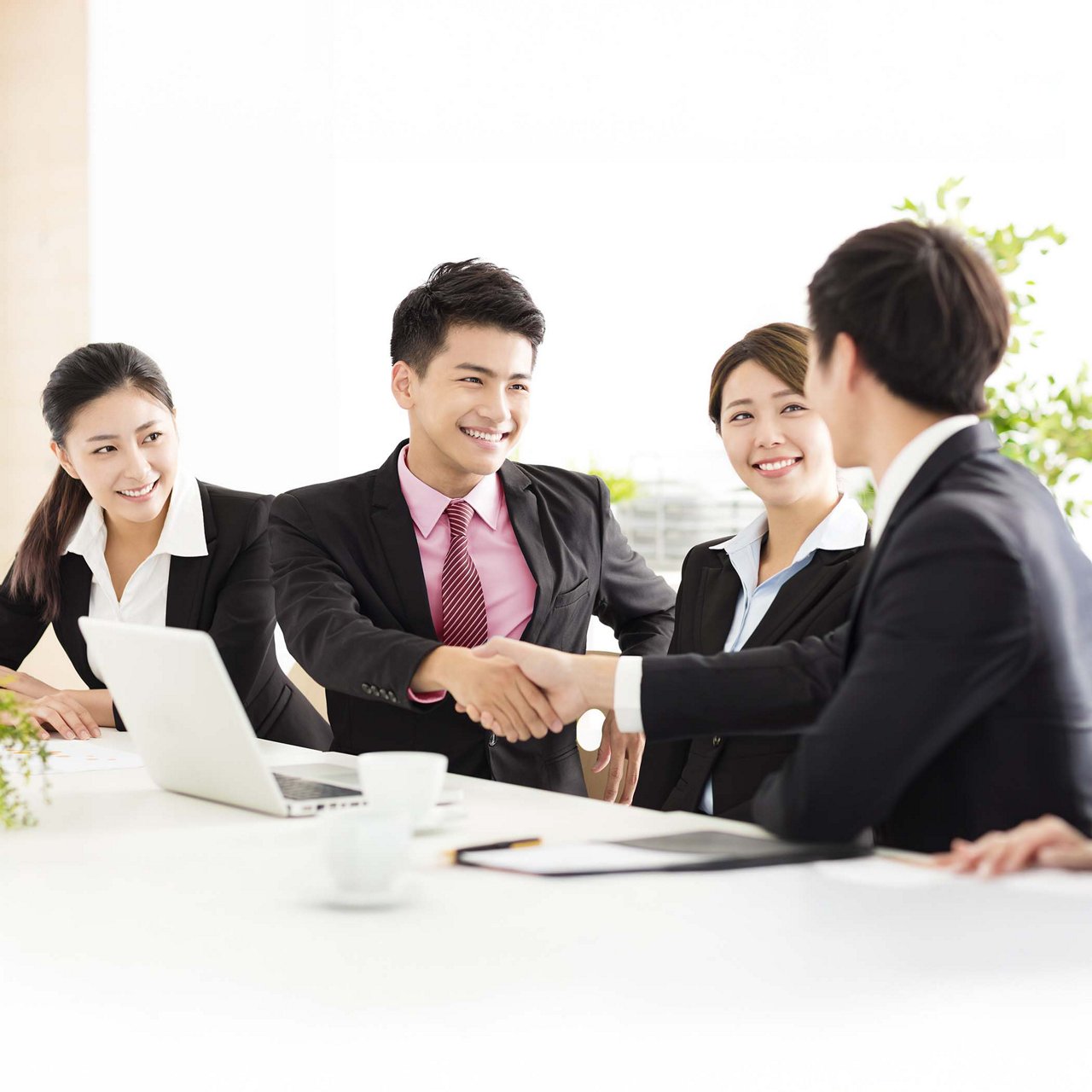 One man in a suit presenting to another