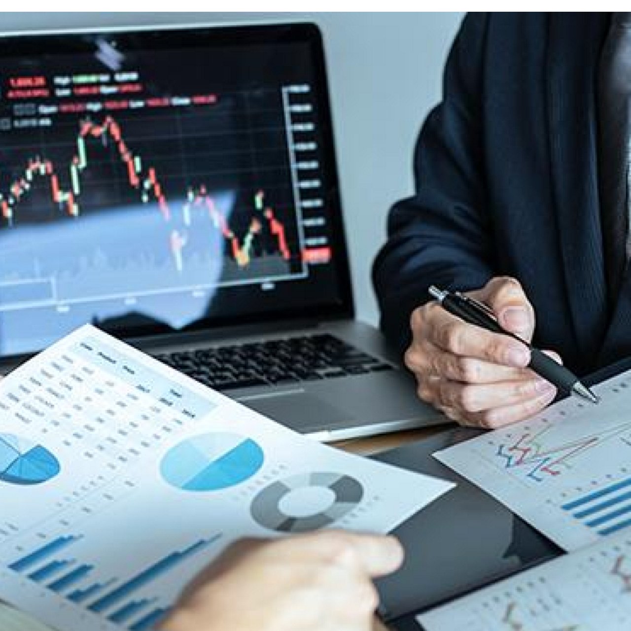 A businessman looking at graphs