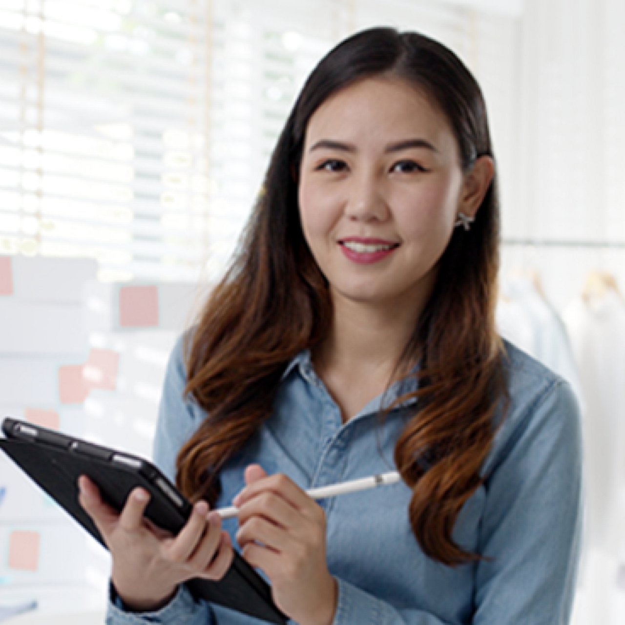A woman holding her phone and talking with a smiling barista