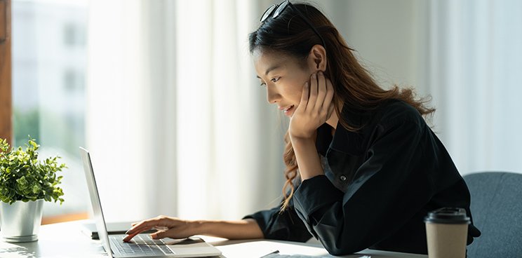 A woman looking at her screen, interested