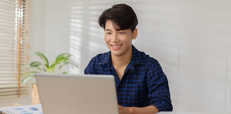 A man looking at a device screen, happy