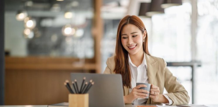 A smiling woman using her phone.