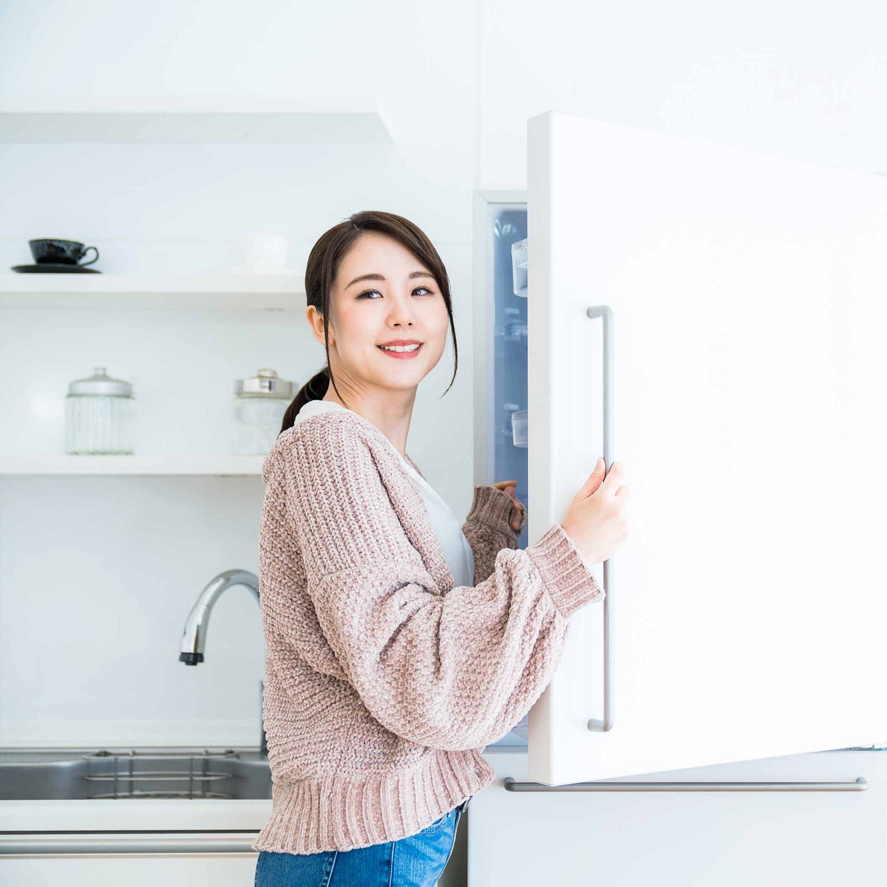 Woman opening a refrigerator