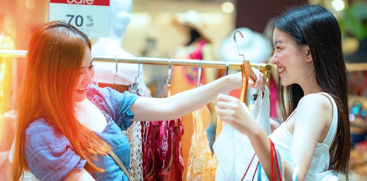 Two women checking out dresses