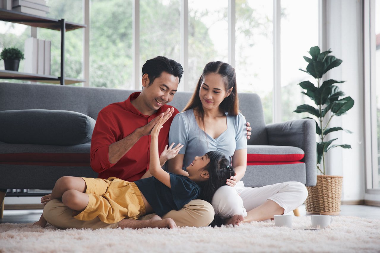 Asian kid cute girl lying on mom and dad happy living relaxing with young mom and dad at home, Happy young family living concept