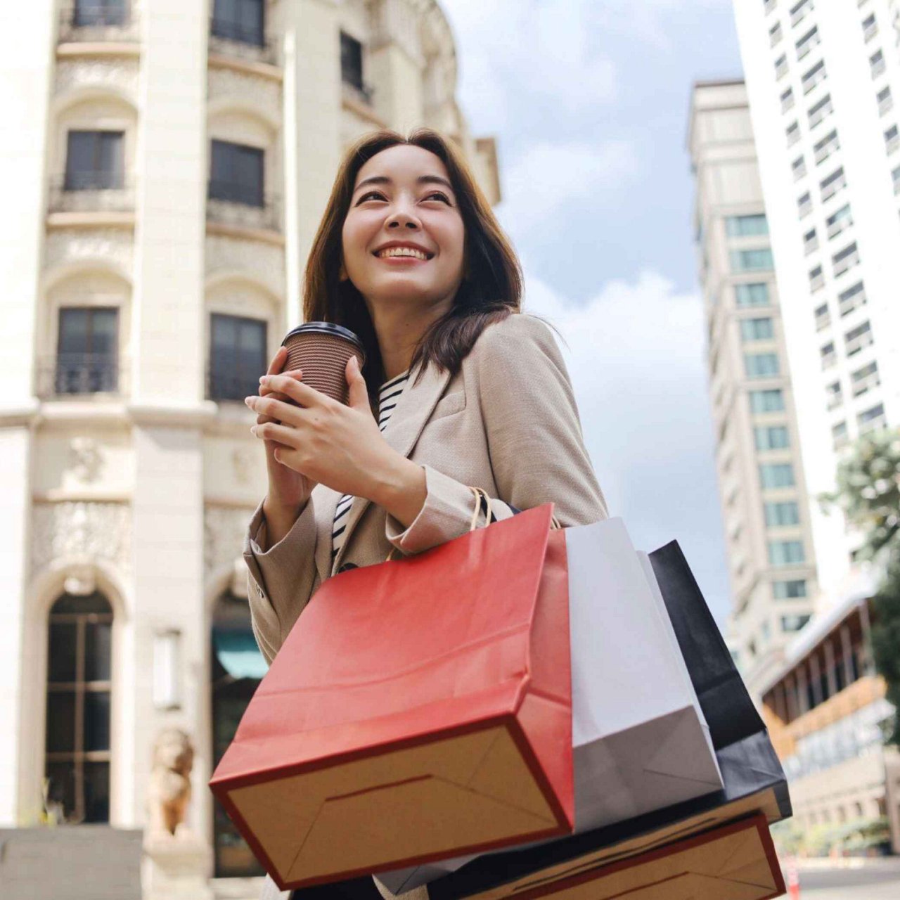 A smiling woman holding her phone.