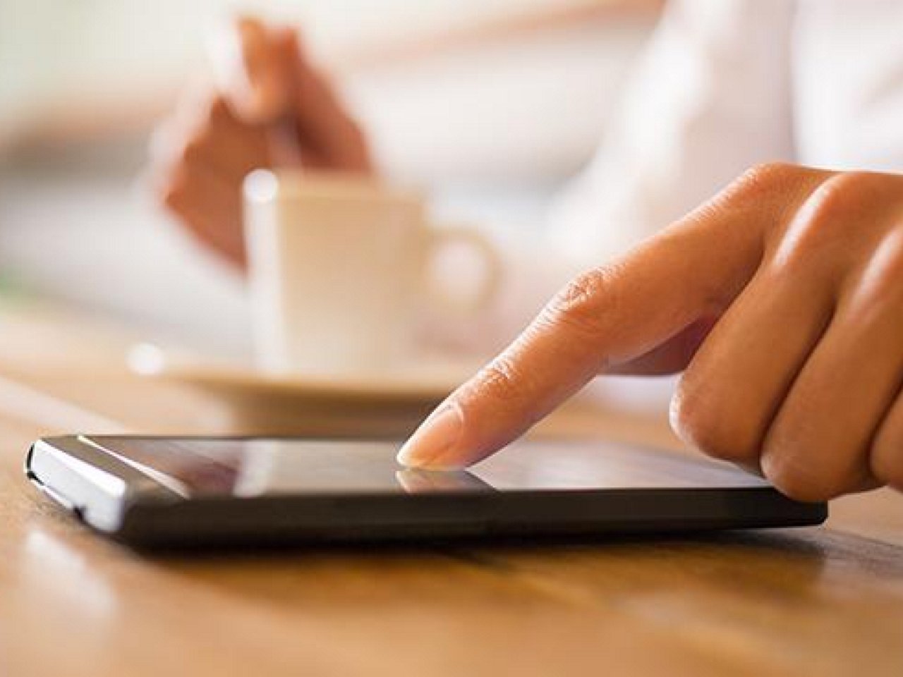 A hand scrolling on a smartphone screen.