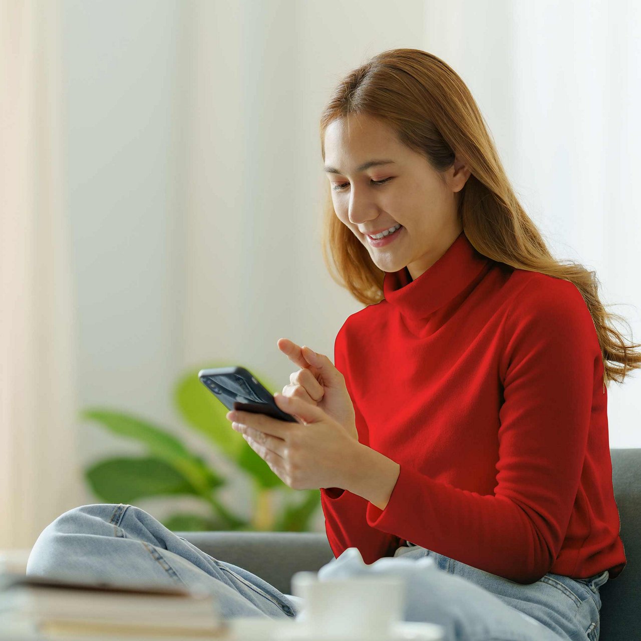 A woman holding her phone and card.