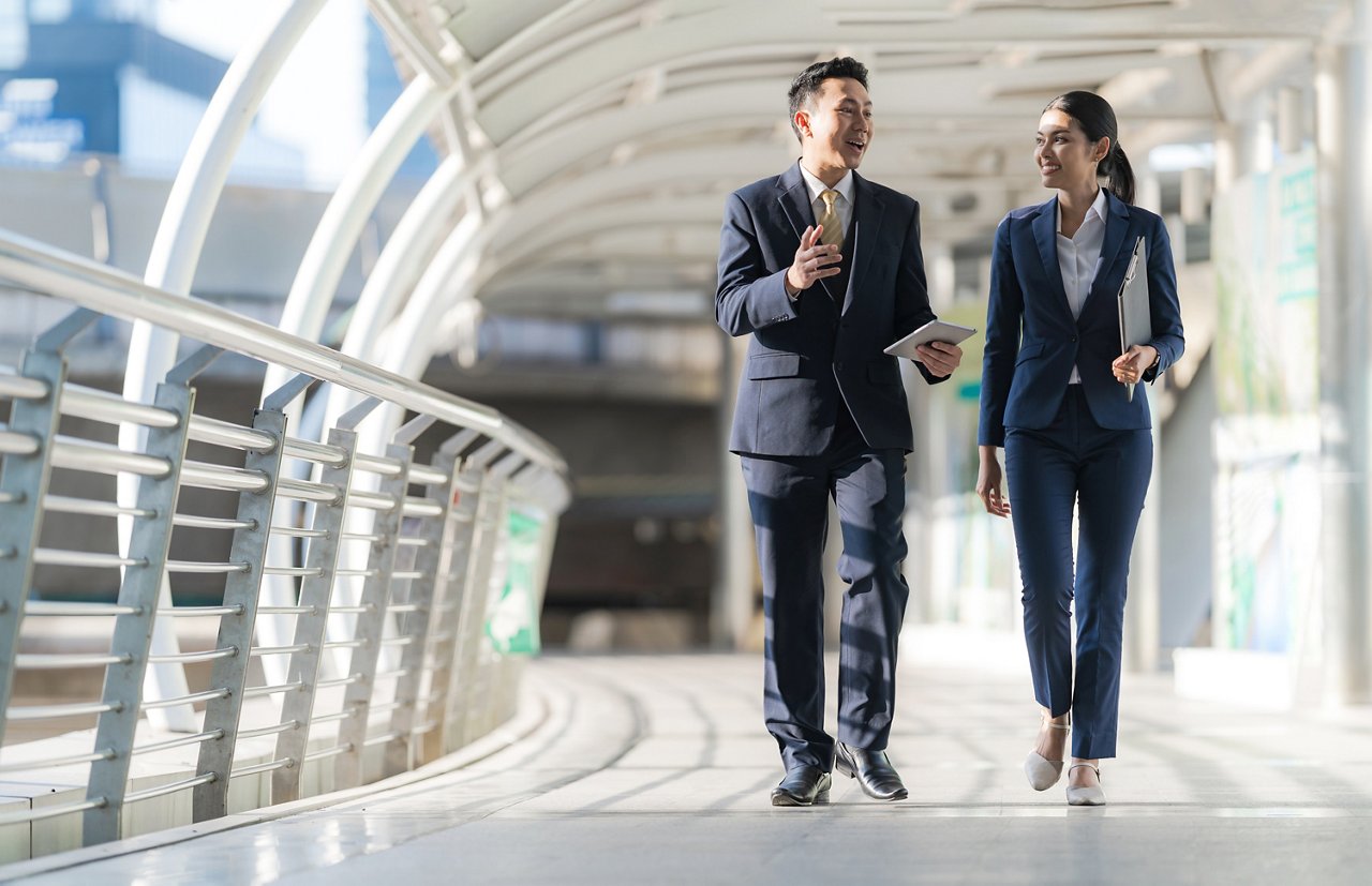 Business people walking and talk to each other in front of modern office 