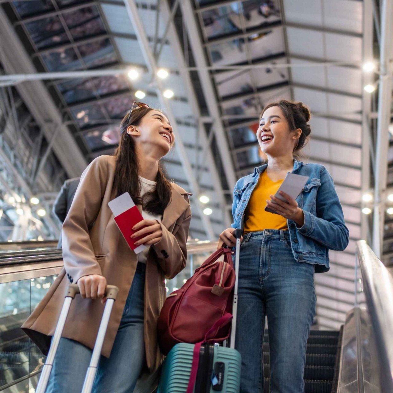 A smiling woman looking at her phone.