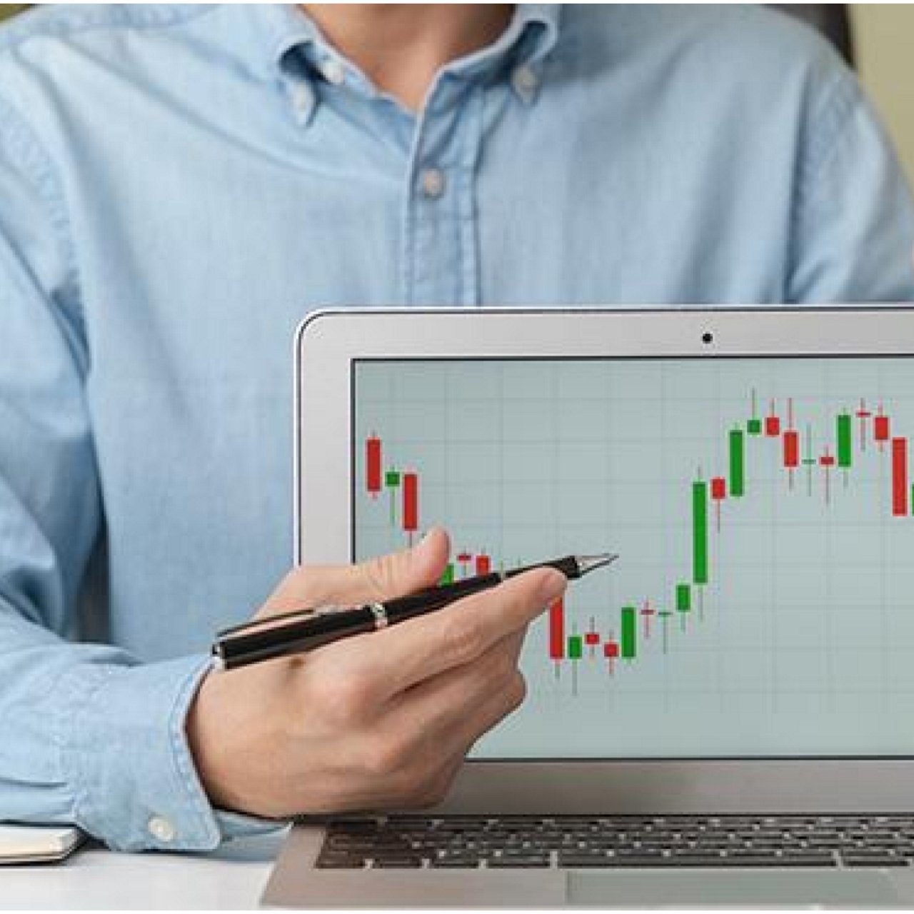 A man showing a graph flashed on a laptop screen.